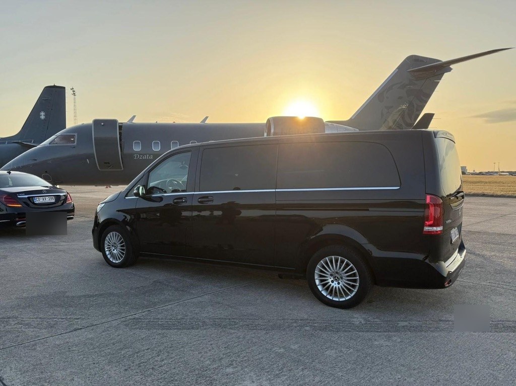 Premium Van in front of private jet